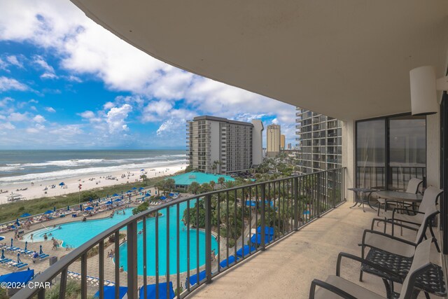 balcony with a view of the beach and a water view