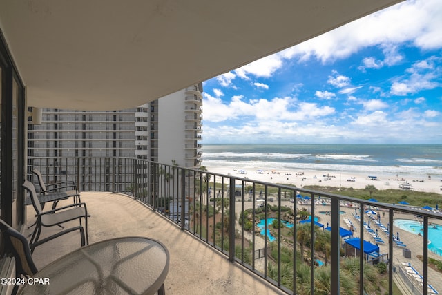 balcony with a view of the beach and a water view