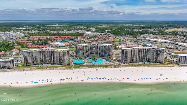 drone / aerial view with a water view and a beach view