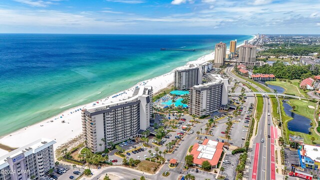 drone / aerial view featuring a beach view and a water view