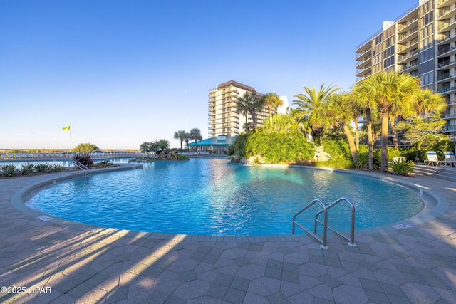 pool with a water view and a patio area