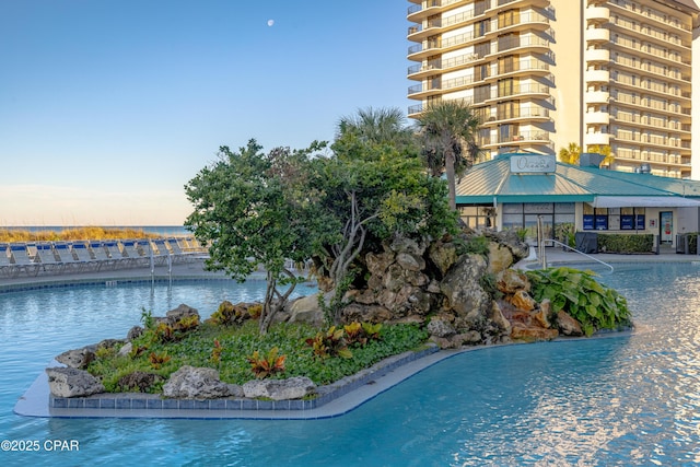 view of swimming pool featuring a water view