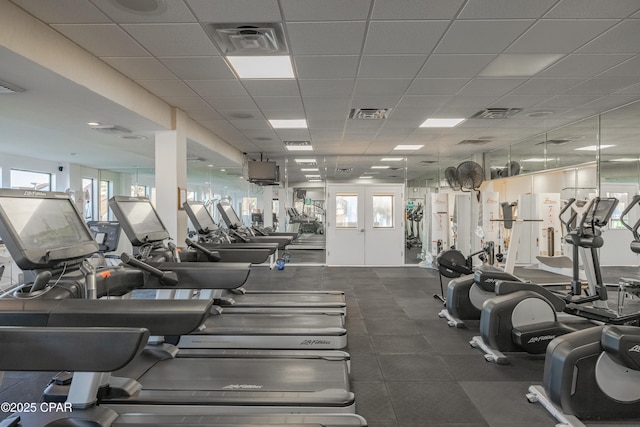 gym featuring a paneled ceiling and visible vents