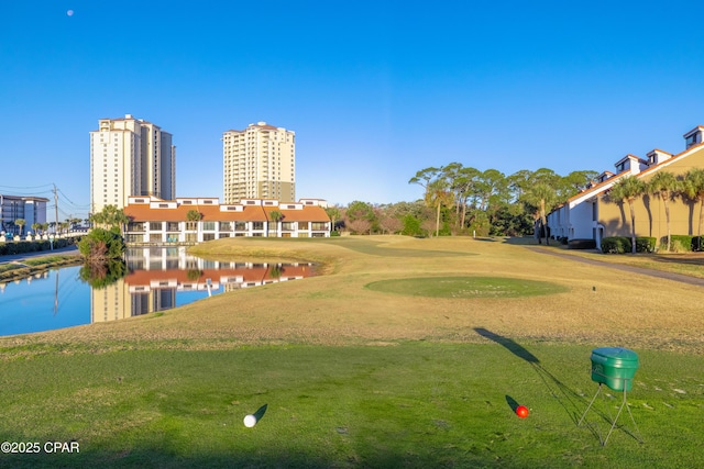 surrounding community with a water view, a city view, and a yard