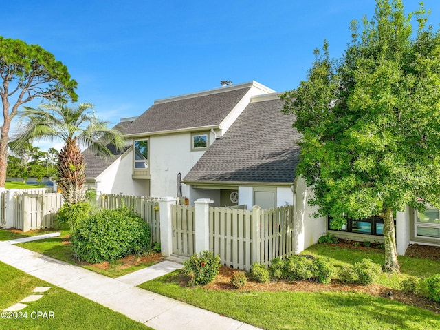 4305 Bay Point Rd Unit 467, Panama City, FL 32408 - view of home's exterior with stucco siding, roof with shingles, and a gate