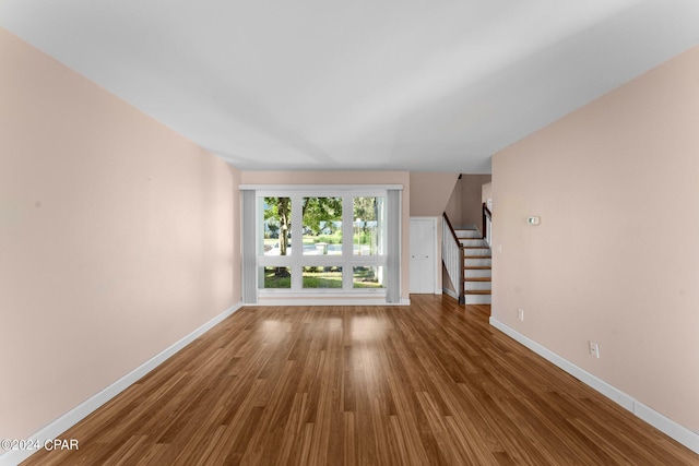 4305 Bay Point Rd Unit 467, Panama City, FL 32408 - unfurnished living room with stairway, baseboards, and wood finished floors
