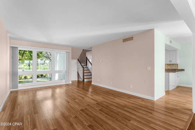 unfurnished living room with light hardwood / wood-style floors