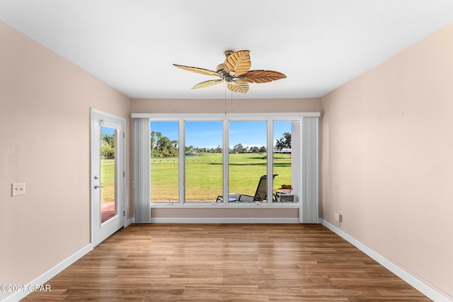 4305 Bay Point Rd Unit 467, Panama City, FL 32408 - spare room with wood finished floors, ceiling fan, baseboards, and golf course view