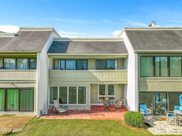 back of property with a patio