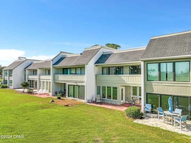 4305 Bay Point Rd Unit 467, Panama City, FL 32408 - rear view of property with roof with shingles, a patio area, a yard, and a balcony