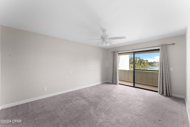 spare room with ceiling fan and light colored carpet