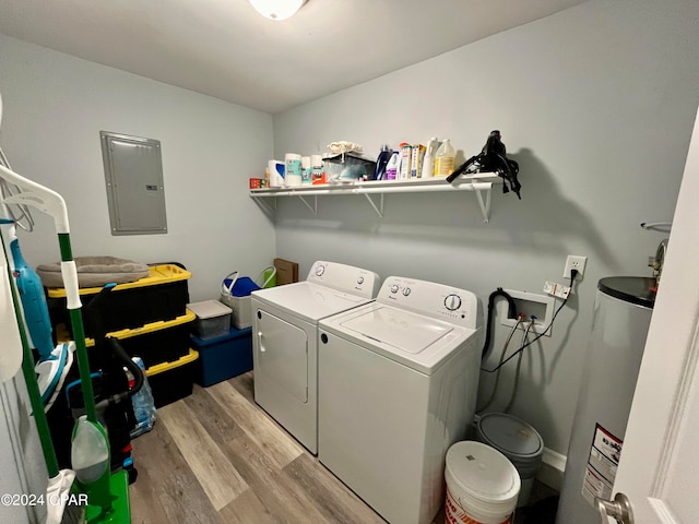 laundry room featuring gas water heater, electric panel, light wood-type flooring, and independent washer and dryer