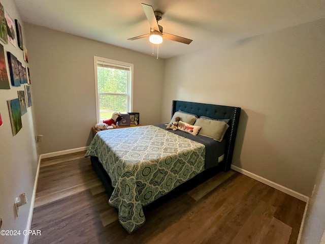 bedroom with ceiling fan and dark hardwood / wood-style floors