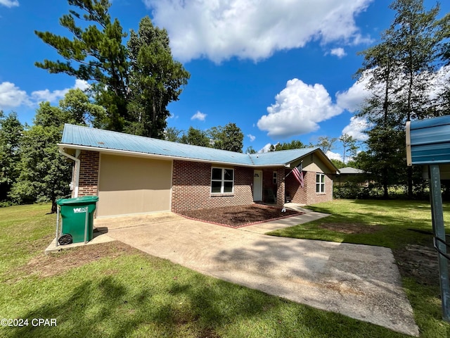 view of front of house with a front lawn and a patio area