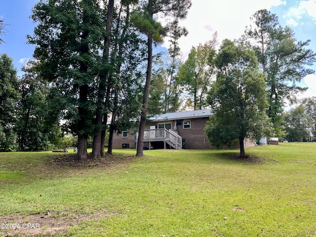 view of yard with central AC unit and a deck