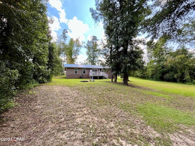 view of yard with a wooden deck