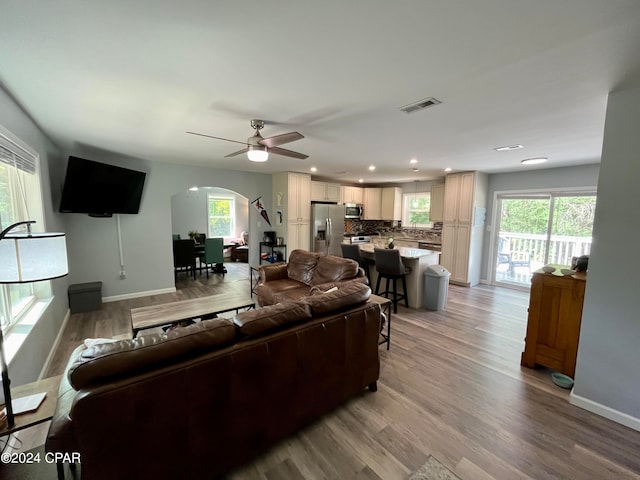 living room featuring light hardwood / wood-style flooring and ceiling fan