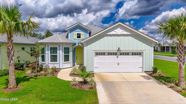 view of front facade with a garage and a front lawn