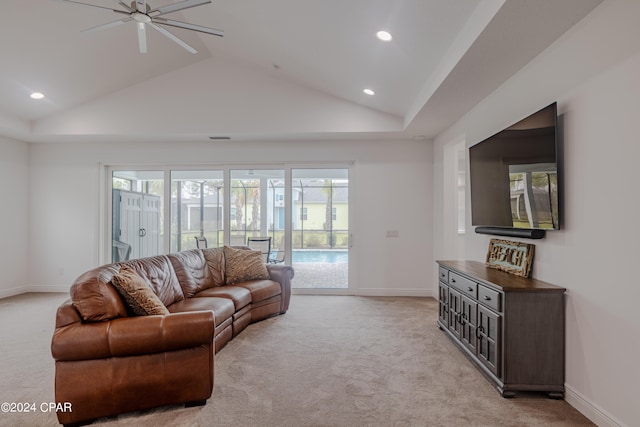 carpeted living room with ceiling fan and lofted ceiling