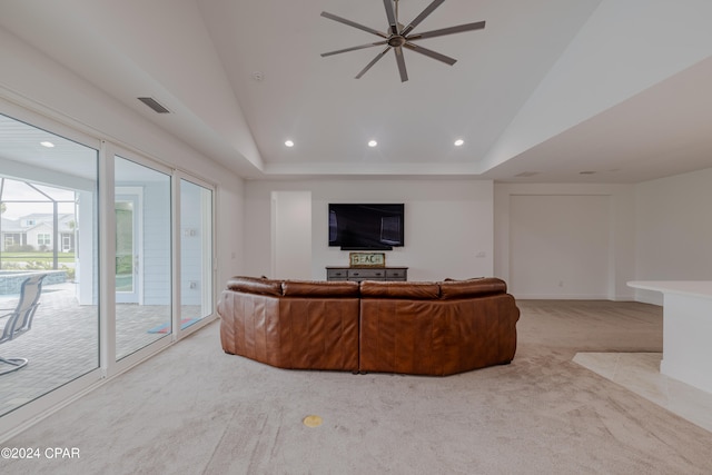 unfurnished living room featuring light carpet, lofted ceiling, and ceiling fan