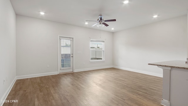 unfurnished room with ceiling fan and dark hardwood / wood-style floors