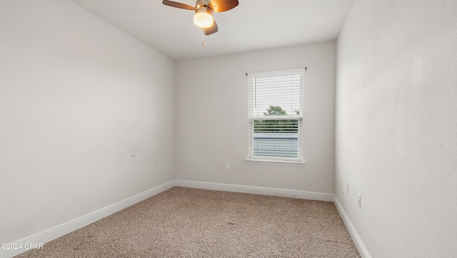 spare room with carpet floors and ceiling fan