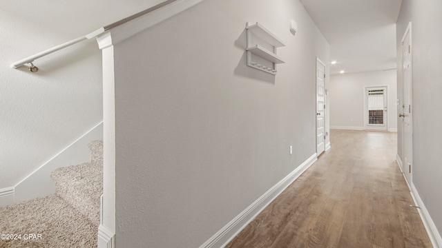 corridor with hardwood / wood-style floors