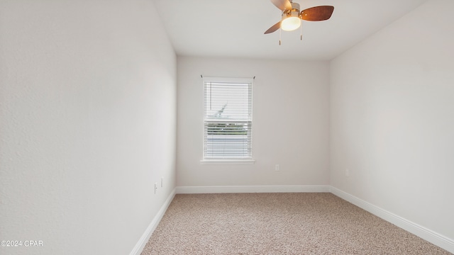 spare room with ceiling fan and carpet