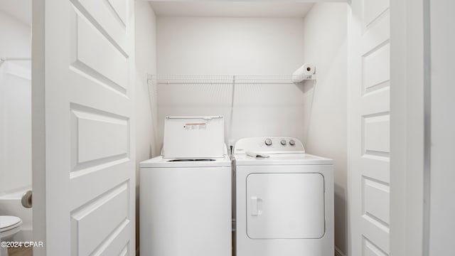 washroom featuring washer and clothes dryer