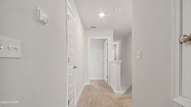 hallway featuring light carpet