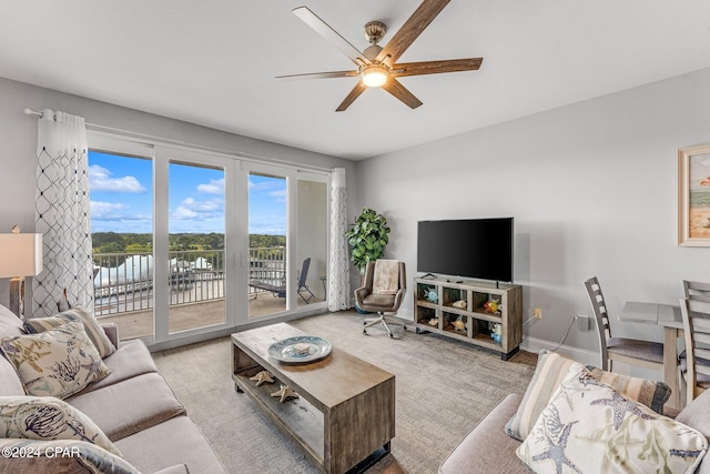 living room with light carpet and ceiling fan