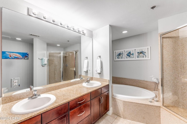 bathroom featuring independent shower and bath, vanity, and tile patterned flooring