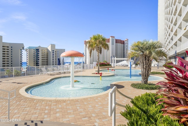 view of swimming pool featuring a patio and pool water feature