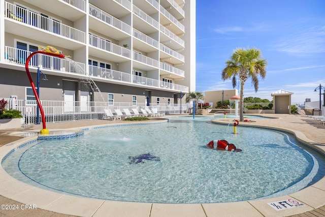 view of pool featuring pool water feature and a patio area