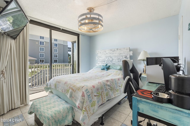 bedroom with floor to ceiling windows, access to outside, an inviting chandelier, light tile patterned floors, and a textured ceiling