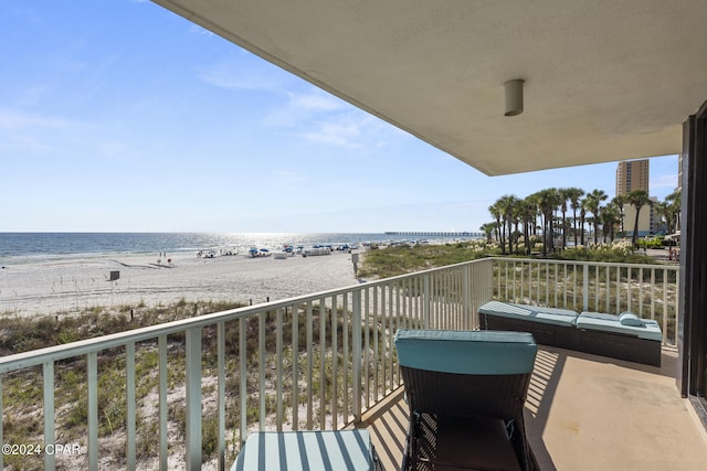 balcony with a water view and a beach view