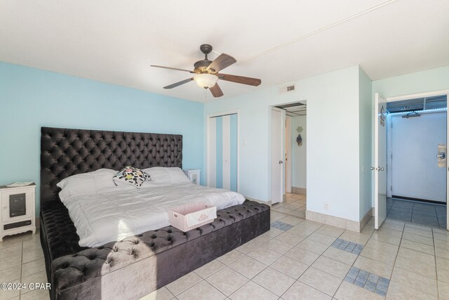 bedroom with ceiling fan and light tile patterned flooring