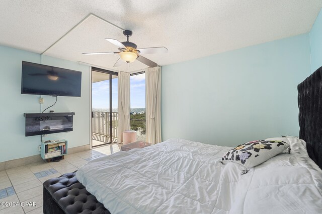 bedroom featuring access to outside, ceiling fan, light tile patterned flooring, and a textured ceiling