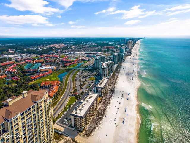 birds eye view of property featuring a water view and a beach view