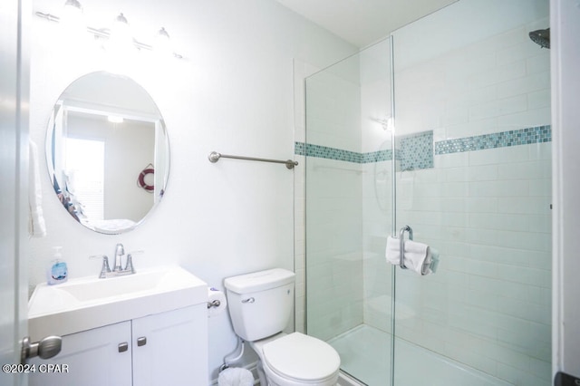 bathroom with walk in shower, vanity, and toilet