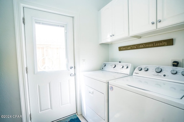 laundry room featuring cabinets and washing machine and dryer