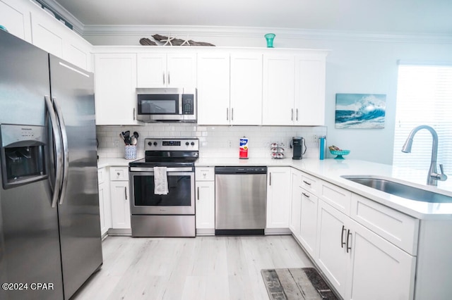 kitchen featuring sink, stainless steel appliances, and white cabinets