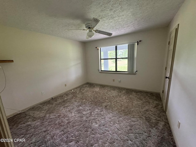 carpeted empty room featuring ceiling fan and a textured ceiling