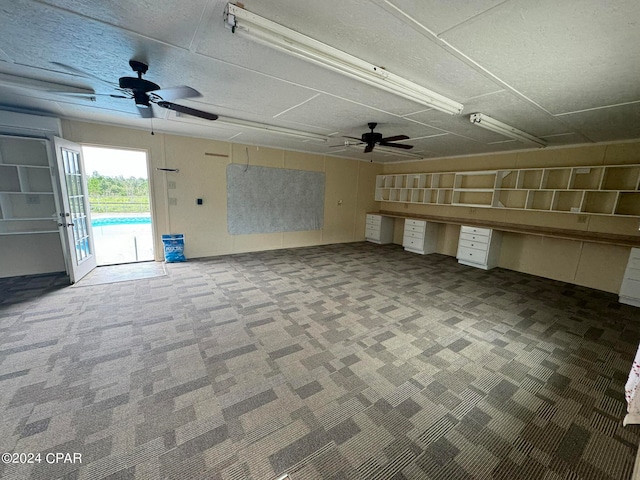 interior space with carpet flooring and ceiling fan