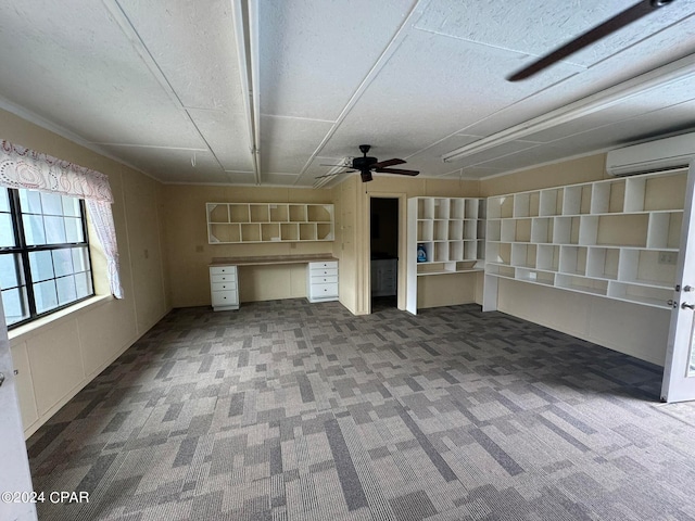 unfurnished living room with a textured ceiling, an AC wall unit, ceiling fan, and dark colored carpet