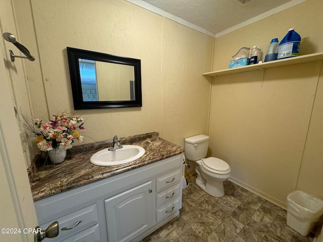 bathroom with vanity, crown molding, toilet, and a textured ceiling