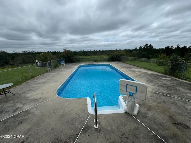 view of pool with a yard and a patio