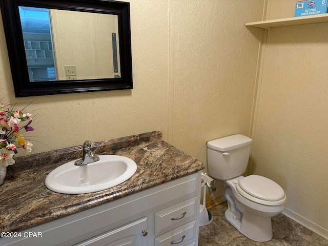 bathroom with vanity, tile patterned flooring, and toilet