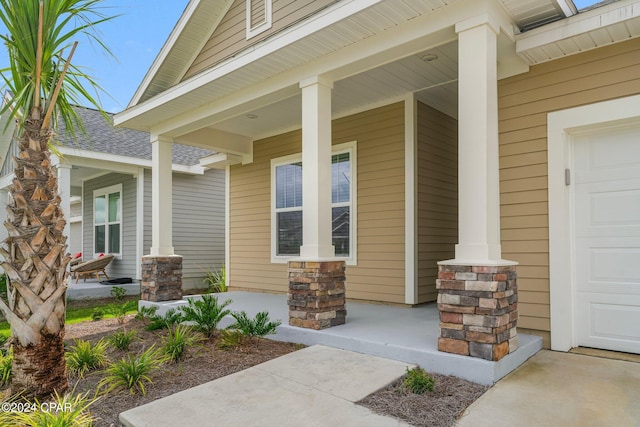 entrance to property with a garage and covered porch