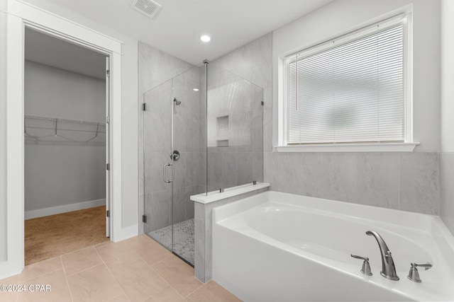 bathroom with tile patterned flooring and plus walk in shower